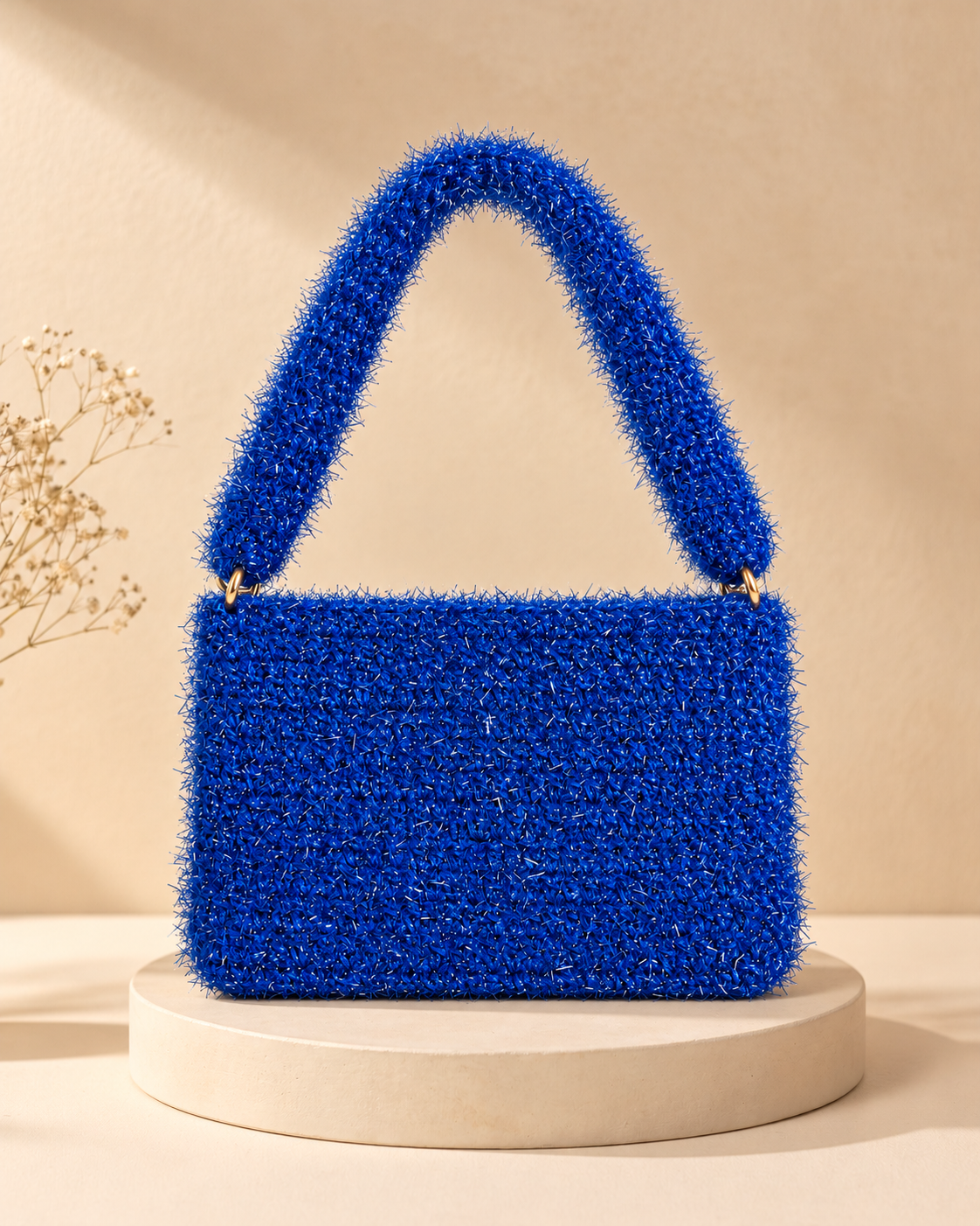 Royal Blue Metallic Crochet Purse — warm beige pedestal product photo