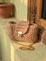 Sona Flap Bag on a sunlit ledge beside a carved wooden window at golden hour