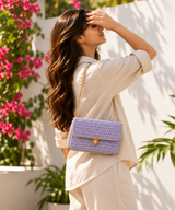 Lilac Grace Flap Bag with thin gold chain carried by model outdoors