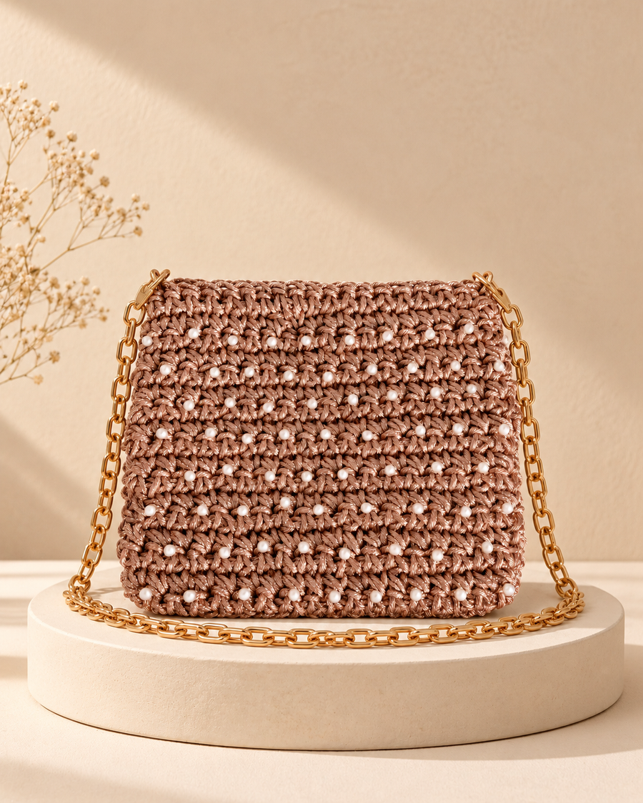 Rose Gold Pearl Crochet Purse — warm beige pedestal product photo