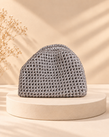 Silver crochet clutch without chain on a cream pedestal, HouseOfReena
