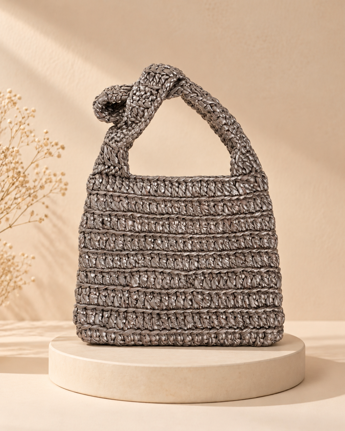 Silver Metallic Crochet Purse — warm beige pedestal product photo